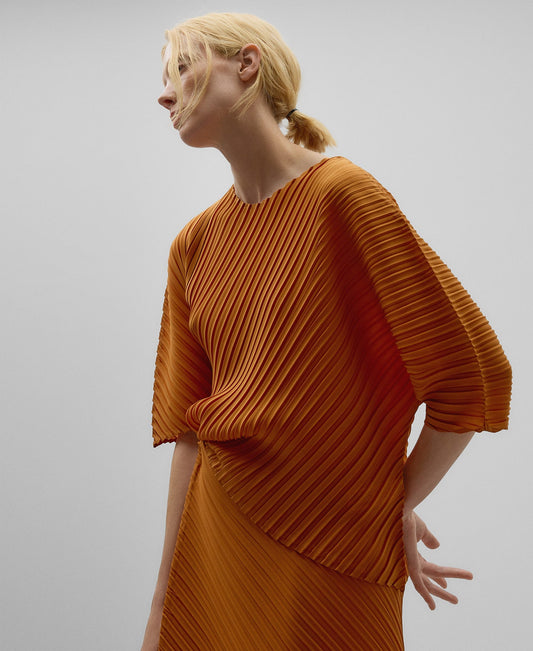 Asymmetrical crinkle top woman in orange