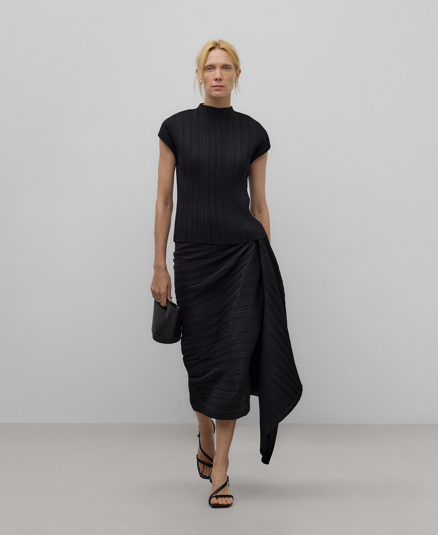 Crinkle skirt gesture on the side woman in black