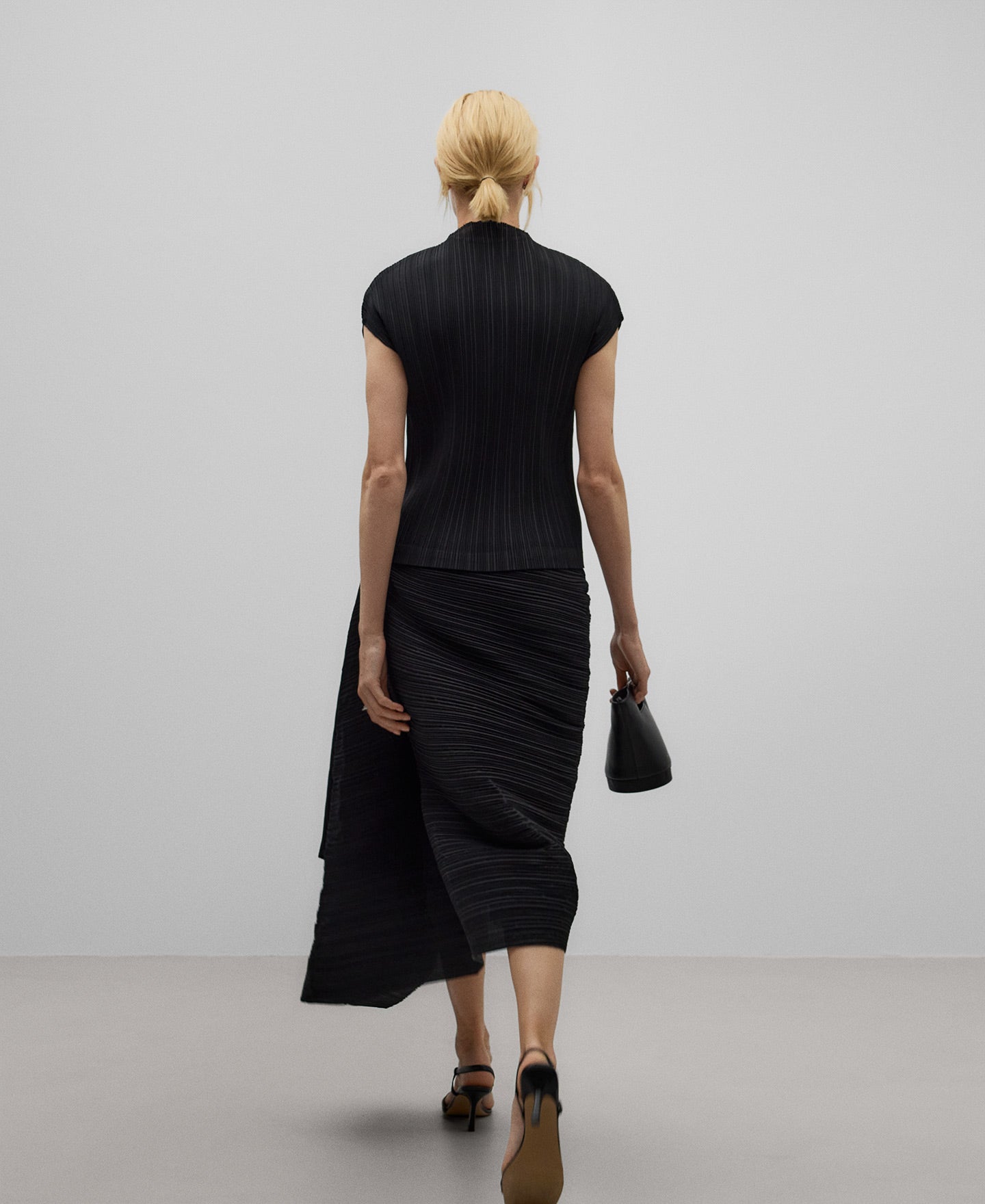 Crinkle skirt gesture on the side woman in black