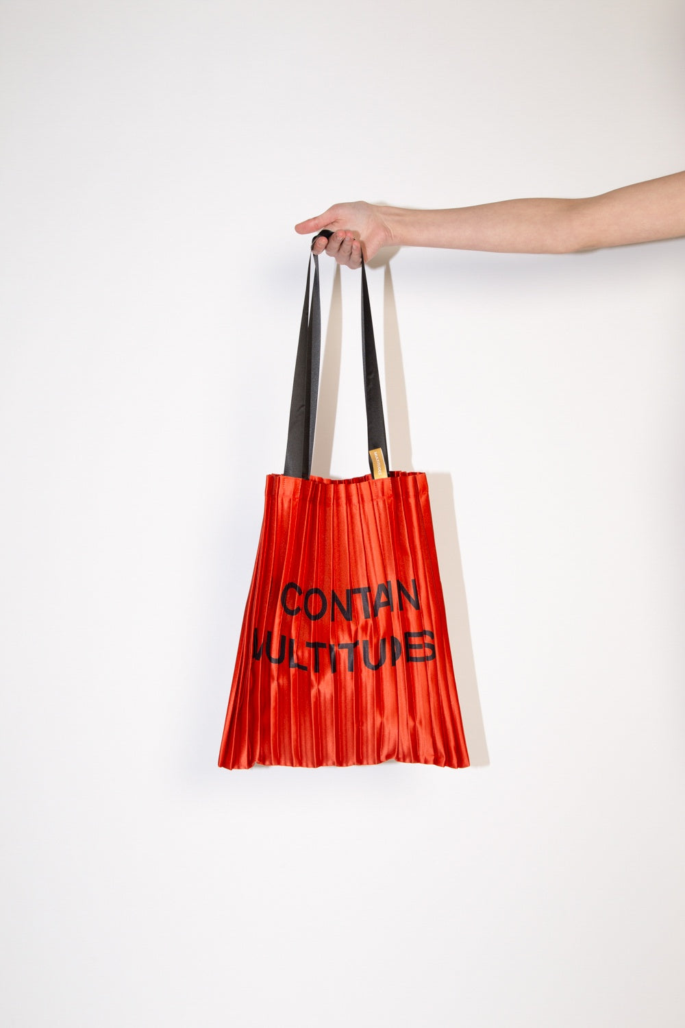 Satin pleated bag “I Contain” Red